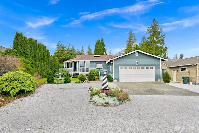 ranch-style home with a porch and a garage