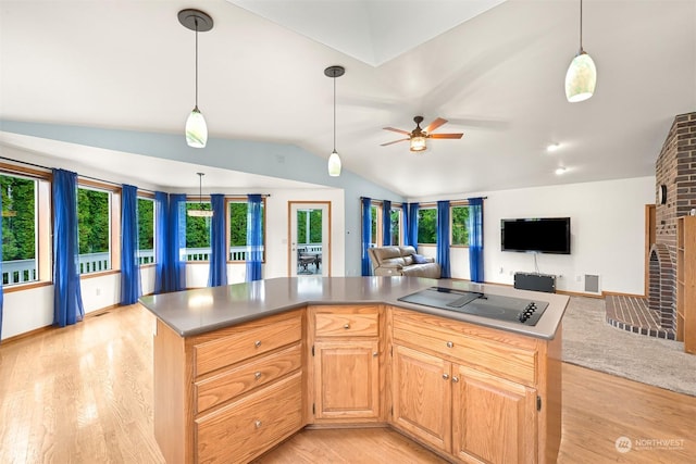 kitchen featuring light hardwood / wood-style floors, a kitchen island, plenty of natural light, and black electric cooktop