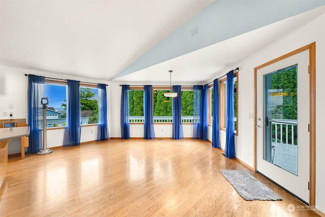 interior space featuring hardwood / wood-style floors and vaulted ceiling