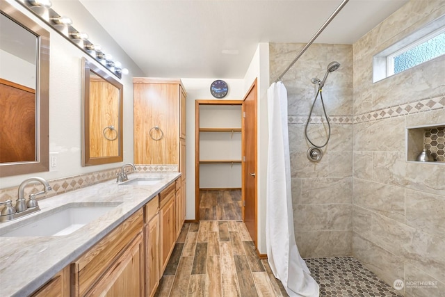 bathroom featuring curtained shower, vanity, and wood-type flooring