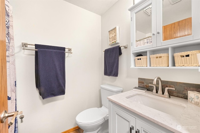 bathroom with vanity and toilet