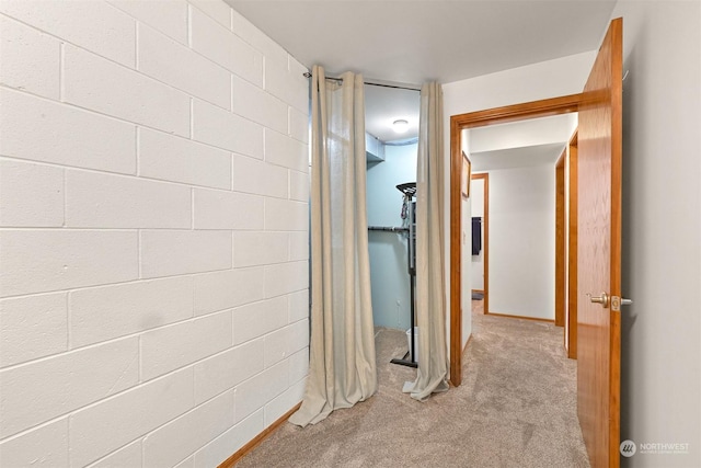 hallway with light colored carpet