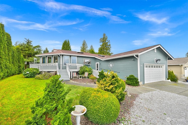 view of front facade with a front lawn, a deck, and a garage