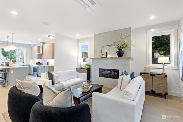 living room with light hardwood / wood-style floors and a fireplace