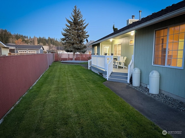 view of yard with a fenced backyard and a deck