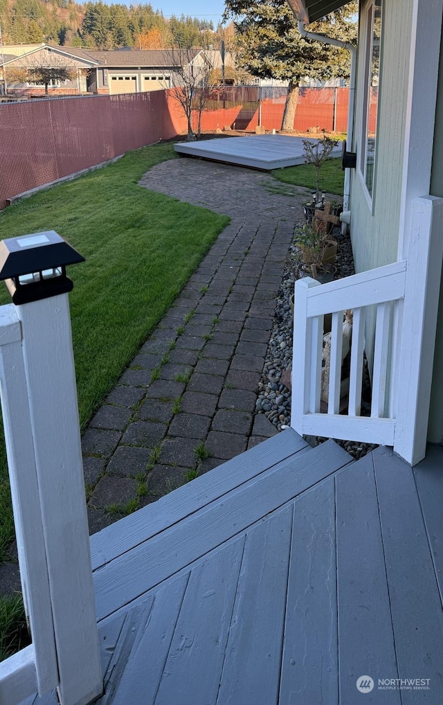 view of yard with a fenced backyard and a wooden deck