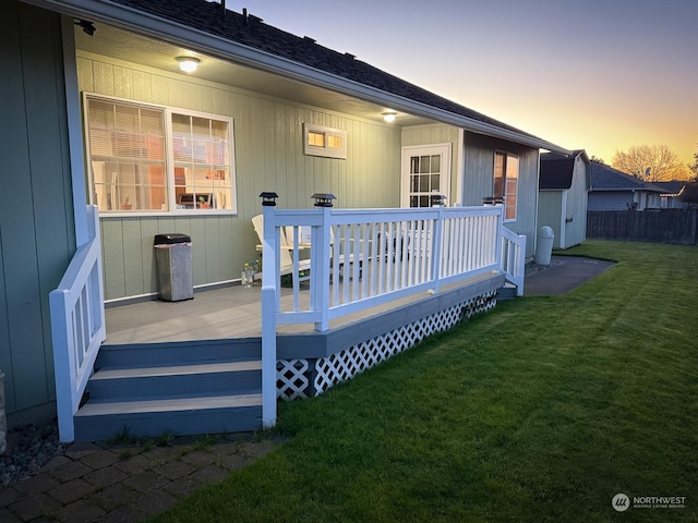 exterior space featuring a deck and a lawn