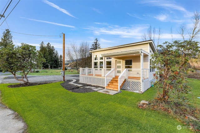 view of front of property with a porch and a front yard