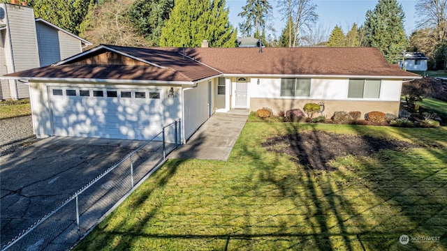 single story home featuring a garage and a front lawn