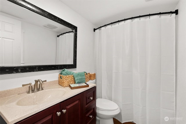 bathroom featuring toilet and vanity