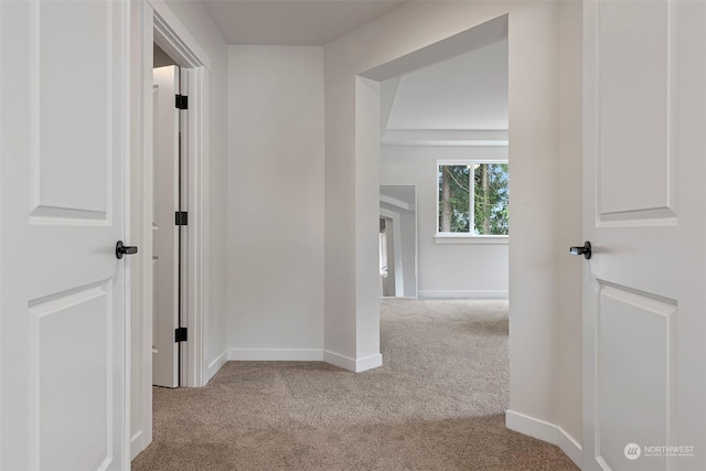 hallway featuring light carpet