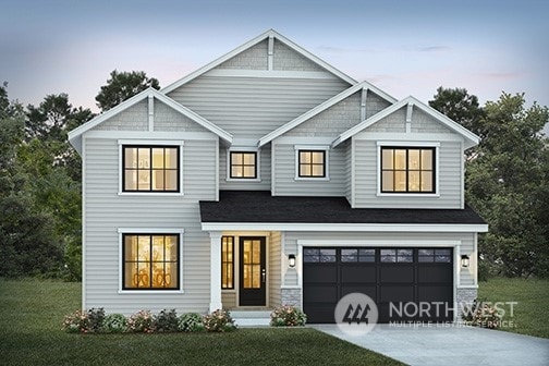 view of front facade with a garage and a yard