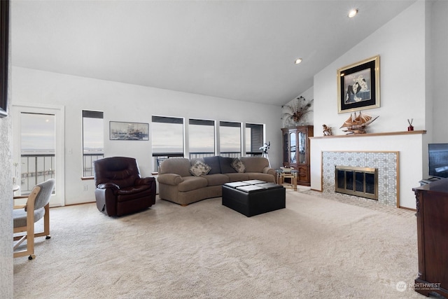 living room with a fireplace, light colored carpet, and plenty of natural light