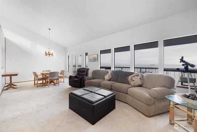 living room with carpet flooring, a water view, a chandelier, and lofted ceiling