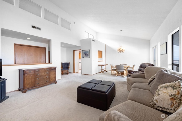 carpeted living room featuring a towering ceiling and an inviting chandelier