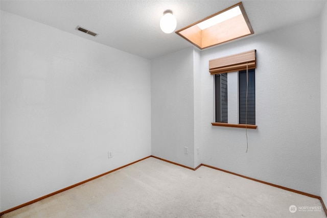 306 E Front St Unit 2, Port Angeles, WA 98362 - carpeted spare room featuring a skylight and baseboards