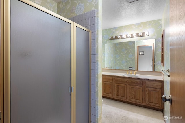 306 E Front St Unit 2, Port Angeles, WA 98362 - bathroom with wallpapered walls, a shower stall, vanity, and a textured ceiling