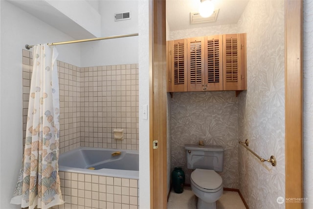 bathroom featuring shower / tub combo and toilet