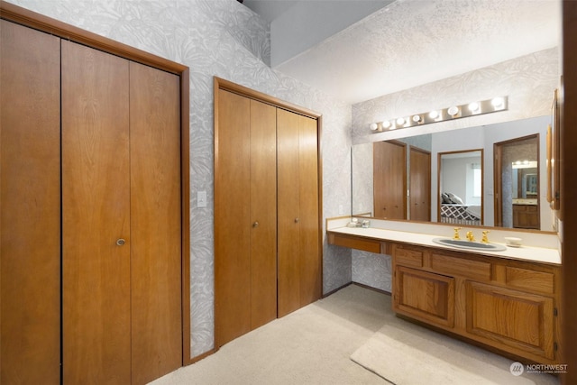 306 E Front St Unit 2, Port Angeles, WA 98362 - bathroom with a closet, wallpapered walls, and vanity