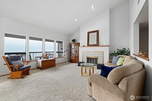 306 E Front St Unit 2, Port Angeles, WA 98362 - living room with high vaulted ceiling, carpet, a tiled fireplace, recessed lighting, and baseboards
