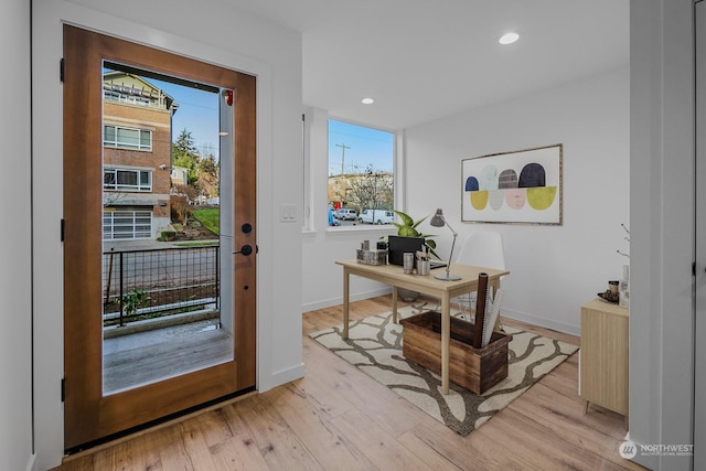 doorway to outside with radiator heating unit and light wood-type flooring