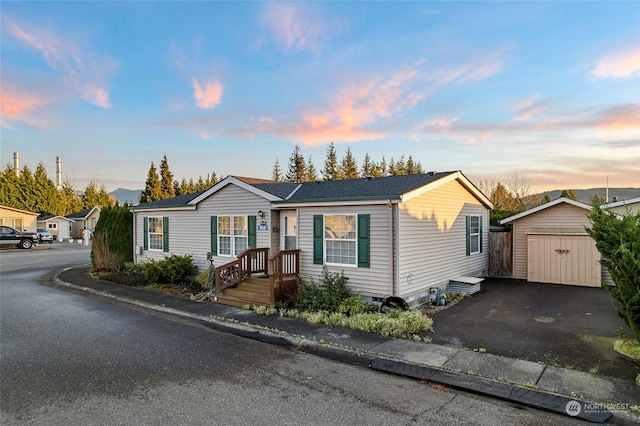 view of front of house featuring a garage and an outdoor structure