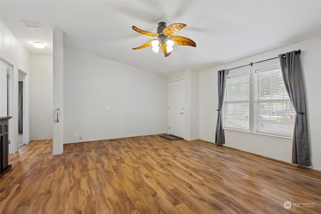 interior space with ceiling fan and wood-type flooring