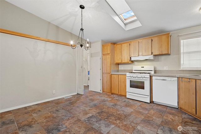 kitchen with white appliances, an inviting chandelier, lofted ceiling with skylight, and hanging light fixtures