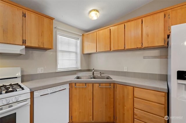 kitchen featuring white appliances, vaulted ceiling, and sink