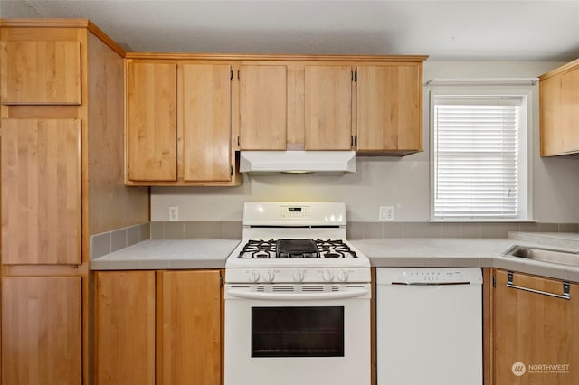 kitchen featuring white appliances and sink