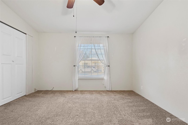 unfurnished bedroom featuring carpet flooring, ceiling fan, and a closet