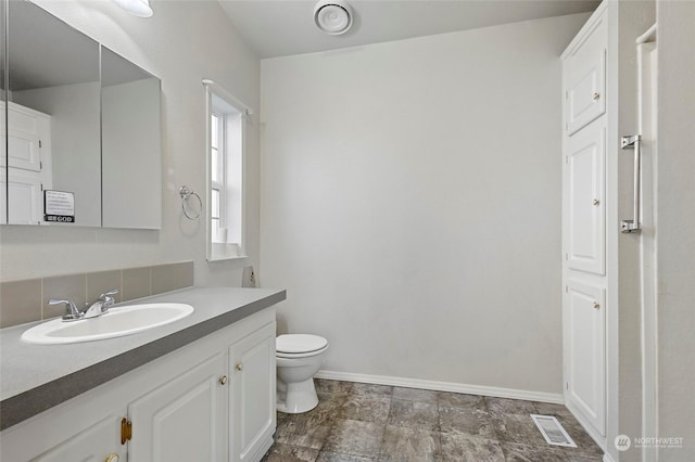 bathroom with vanity and toilet