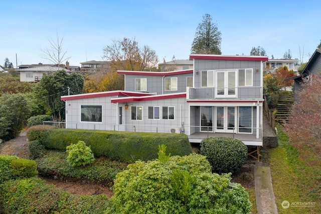 back of property with a balcony