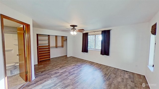 unfurnished bedroom featuring ceiling fan, light wood-type flooring, and a closet