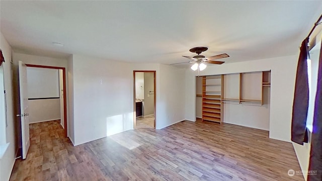 interior space with connected bathroom, light hardwood / wood-style floors, a closet, and ceiling fan