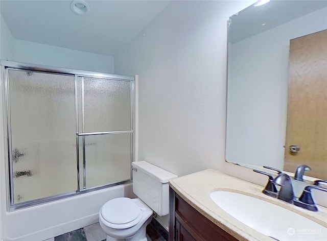 full bathroom with vanity, toilet, and combined bath / shower with glass door