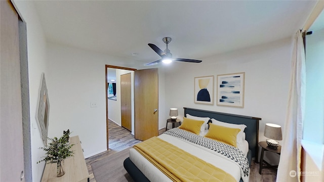 bedroom with wood-type flooring and ceiling fan