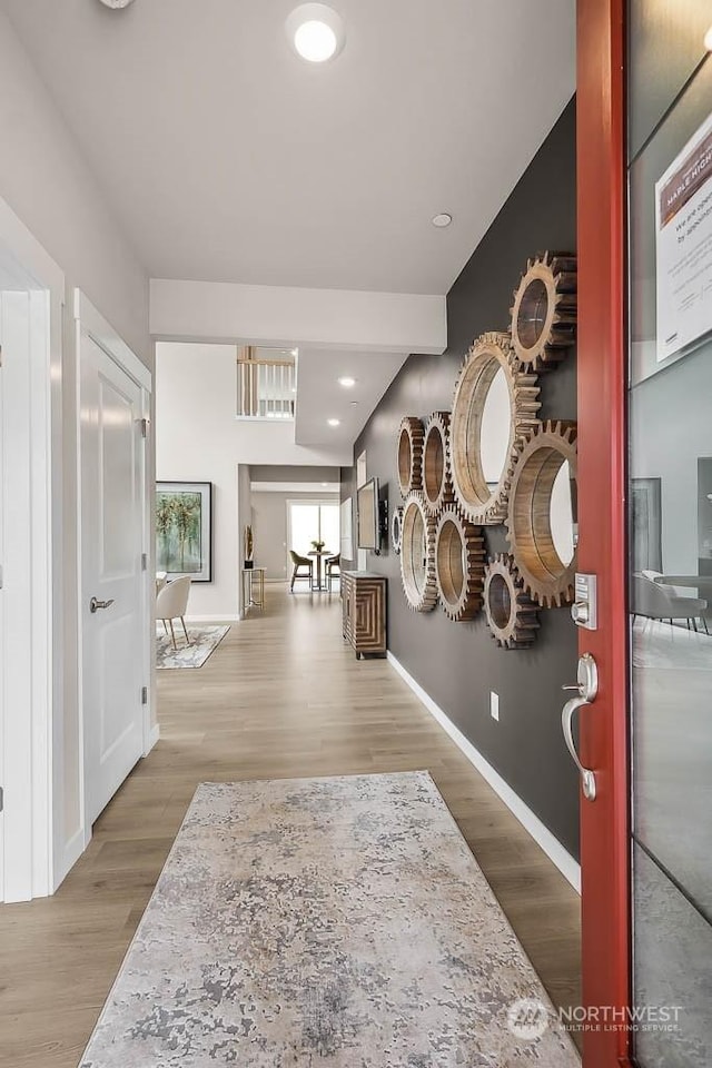 corridor with hardwood / wood-style flooring