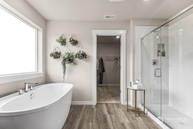 bathroom with separate shower and tub and hardwood / wood-style floors