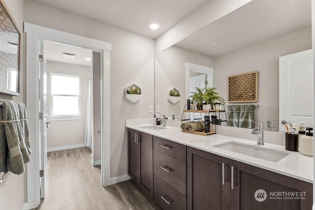 bathroom featuring vanity, hardwood / wood-style flooring, and backsplash