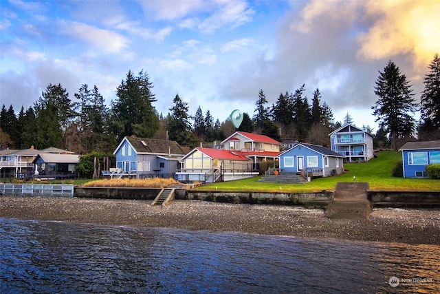 exterior space with a yard and a water view