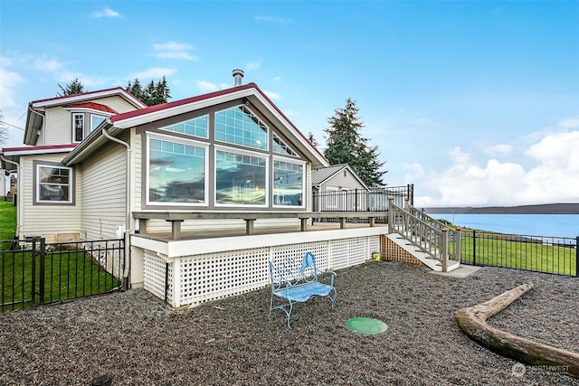 back of property featuring a deck with water view