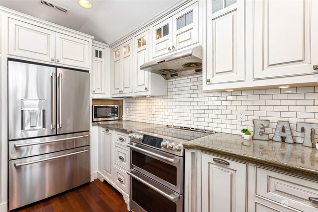 kitchen featuring white cabinetry, dark hardwood / wood-style flooring, stainless steel appliances, and stone countertops