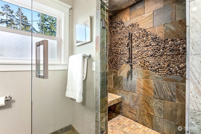 bathroom with tiled shower