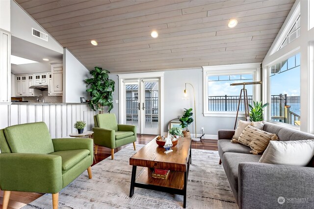 living room featuring french doors, wooden ceiling, light hardwood / wood-style flooring, and lofted ceiling