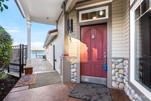 doorway to property with a water view