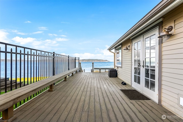 wooden deck featuring french doors and a water view