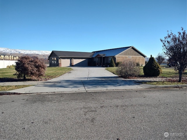 view of front of home featuring a garage and a front lawn