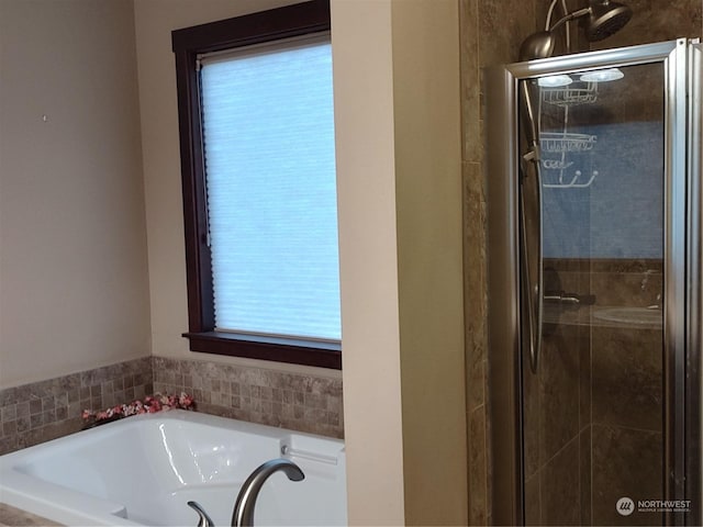 bathroom featuring separate shower and tub