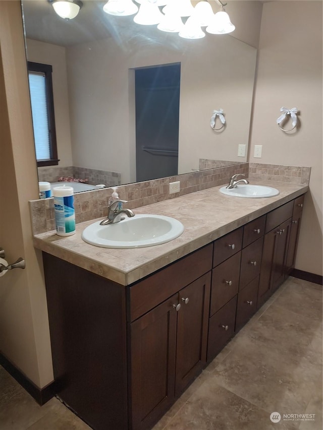 bathroom with vanity and tasteful backsplash